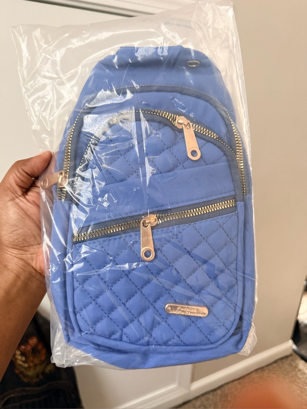 Quilted Blue Sling Backpack with Gold Zippers